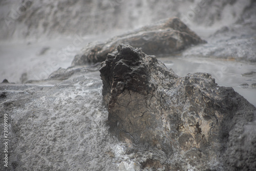 gray stone texture in rotorua geyser in new zealand with water