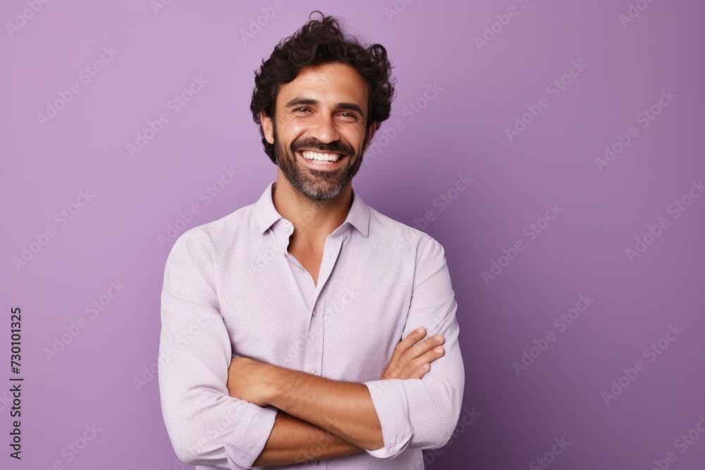 Portrait of a happy young man standing with arms crossed against purple background Portrait of a happy young man standing with arms crossed against purple background