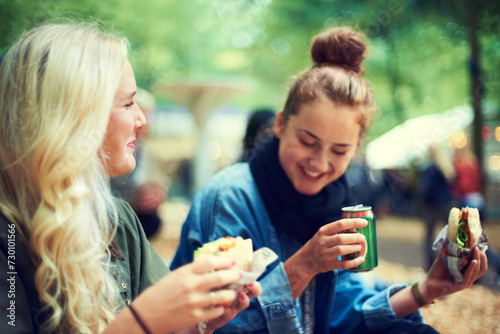 Snack, women and music festival with friends, conversation and happiness with joy and bonding together. People, outdoor and girls with fast food and takeaway with summer break or concert with culture