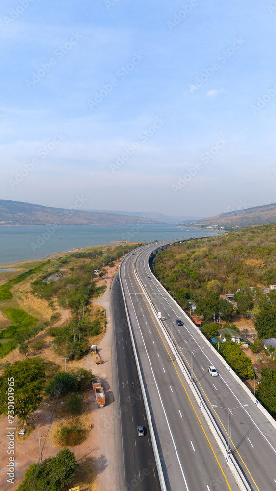 The M6  motorway Expressway Nakhon Ratchasima Province - Bang Pa-in. Lam Ta Khong River and Mountain. Drone shot of scenic landscape rural place traffic. Nakhon Ratchasima Thailand. Motorway Korat
