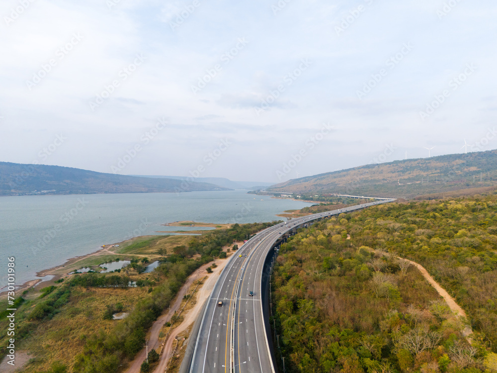 The M6 motorway Expressway Nakhon Ratchasima Province - Bang Pa-in. Lam Ta Khong River and Mountain. Drone shot of scenic landscape rural place traffic. Nakhon Ratchasima Thailand. Motorway Korat The M6 motorway Expressway Nakhon Ratchasima Province - Bang Pa-in. Lam Ta Khong River and Mountain. Drone shot of scenic landscape rural place traffic. Nakhon Ratchasima Thailand. Motorway Korat