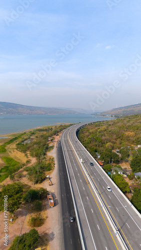 The M6 motorway Expressway Nakhon Ratchasima Province - Bang Pa-in. Lam Ta Khong River and Mountain. Drone shot of scenic landscape rural place traffic. Nakhon Ratchasima Thailand. Motorway Korat