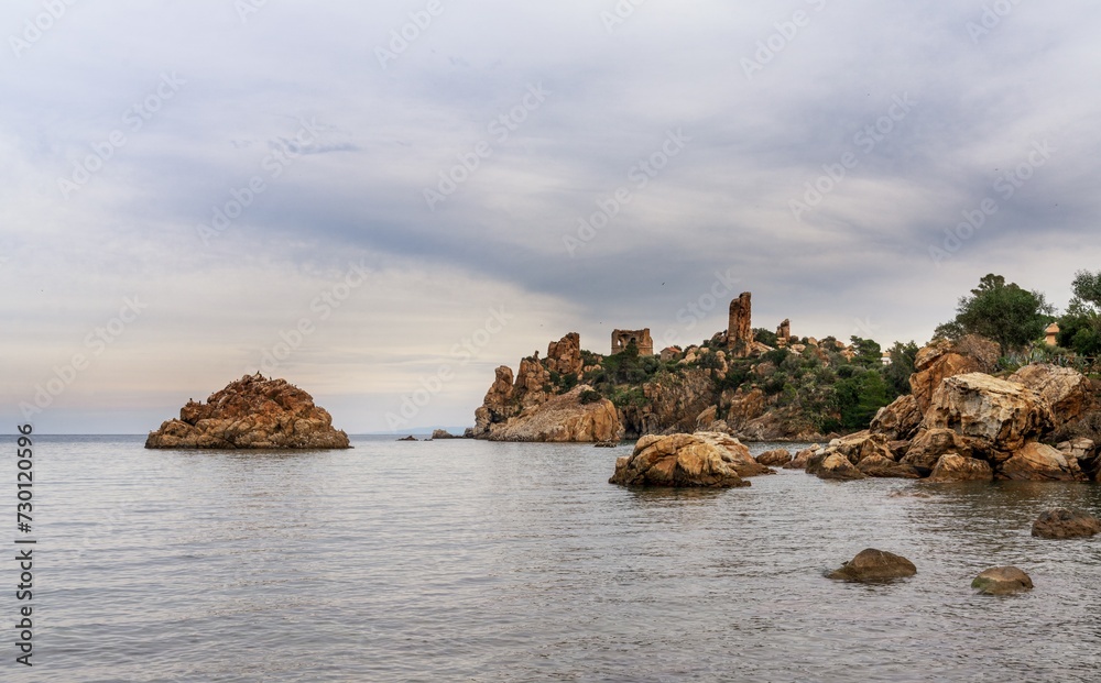 view of the historic Torre Caldura and ruins in the Cefalu Port in Sicily