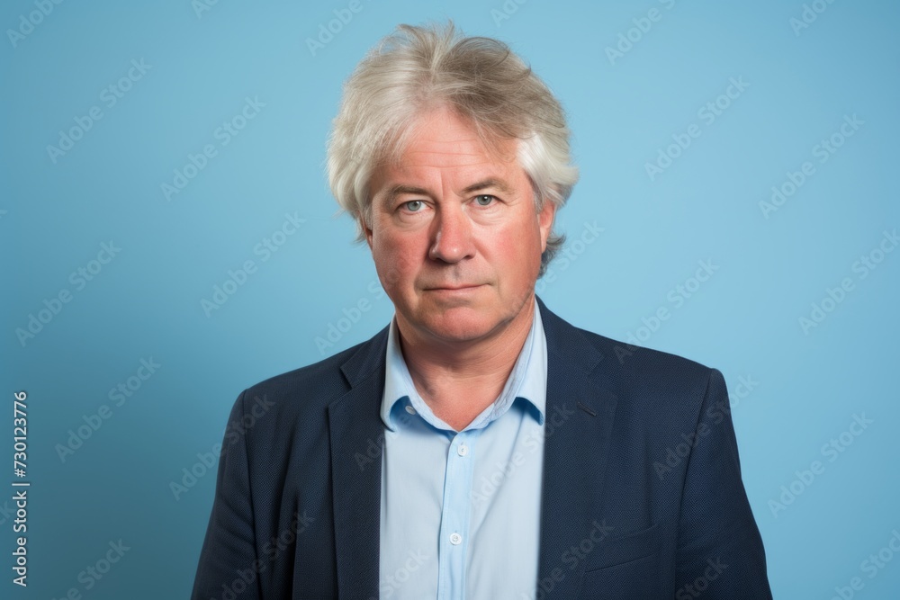 Portrait of senior business man with grey hair over blue background. Portrait of senior business man with grey hair over blue background.