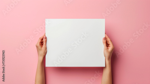 Photo of lady with expressing support, understanding, or kindness, holding hands paper, side white empty space poster proposing buy advert place, isolated on solid color background photo