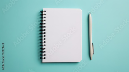 Blank notebook and pen on blue background photo