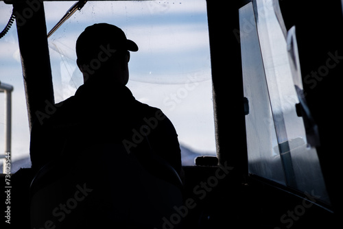 boat skipper against light sailing photo