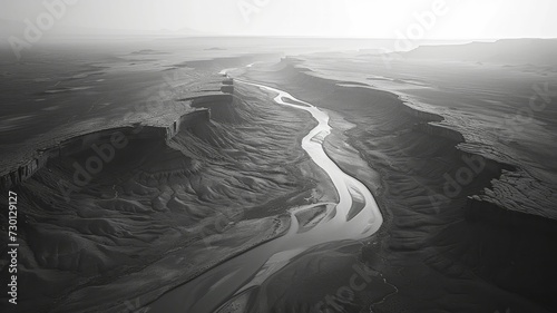 Overhead shot of a river's curving path through the Painted Desert, highlighting its neat contours against the stark landscape.