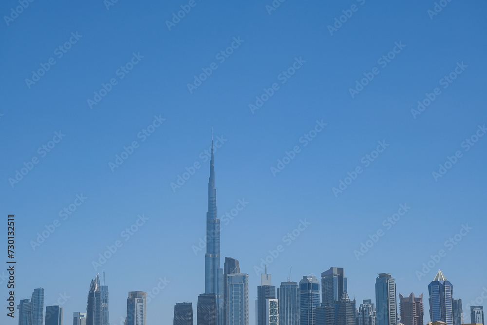 Futuristic and modern commercial and residential highrise tower skyscraper architecture with glass facades and clean lines in downtown Dubai, United Arab Emirates for millionaires and high society