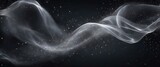 Abstract, graceful, ethereal wave of smoke or mist, illuminated and surrounded by sparkling particles against a dark background.