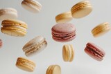 pink yellow and grey macarons floating on  white background