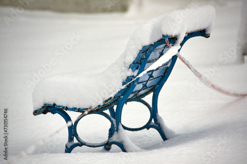 snow covered bench in winter photo
