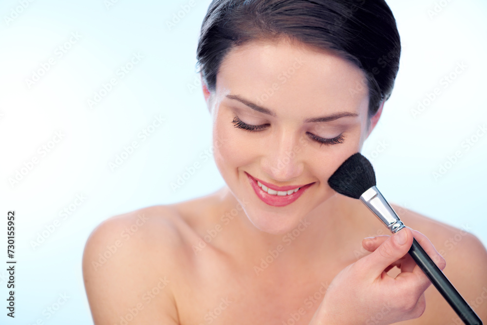 Woman, happy and makeup brushes in studio with beauty, cosmetic tools or product application for skincare. Model, smile and confidence with skin wellness, cosmetology or grooming on blue background Woman, happy and makeup brushes in studio with beauty, cosmetic tools or product application for skincare. Model, smile and confidence with skin wellness, cosmetology or grooming on blue background