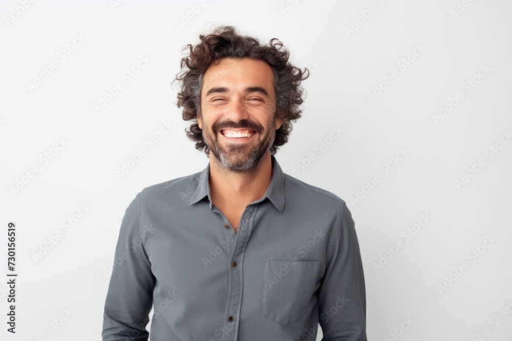 Portrait of a handsome man with curly hair smiling at the camera Portrait of a handsome man with curly hair smiling at the camera