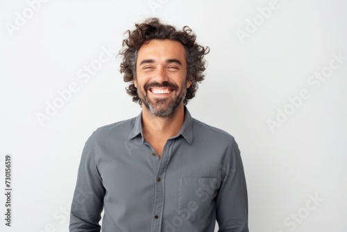 Portrait of a handsome man with curly hair smiling at the camera