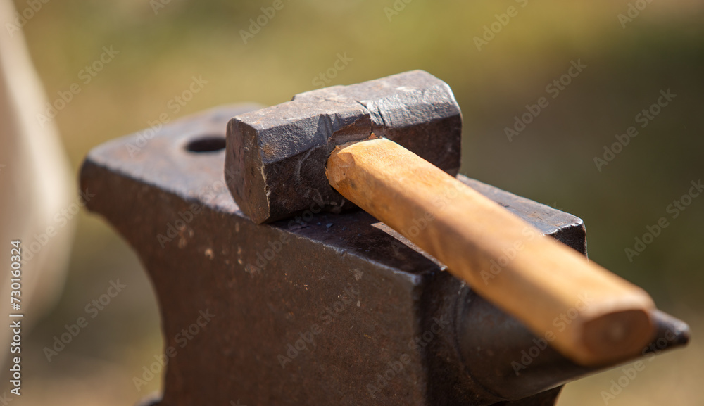 old hoe-hammer on the street in the hand of a man old hoe-hammer on the street in the hand of a man