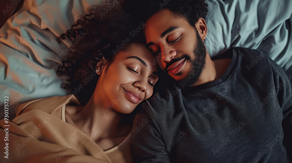 Young multiethnic couple hugging lying bed at home cuddling.