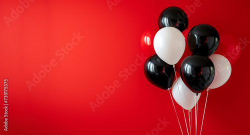 Black and white balloons on red background