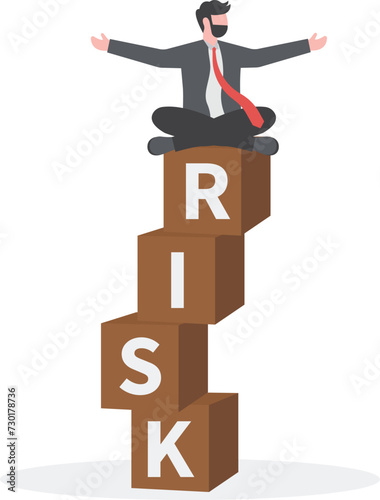 Risk management, control or access to lose money in investing, process or preparation for safety or secure earning and loss concept, businessman investor calmly meditate on stack with the word RISK.

