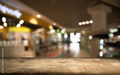 Empty wood table for product display in blur background of admirable restaurant at night. High quality photo