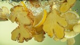 Freeze Motion of Ginger and Lemon Slices Falling into Water.