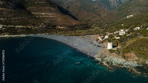 Drone photography of Nonza black beach with black pebbles and turquoise waters in Cap Corse