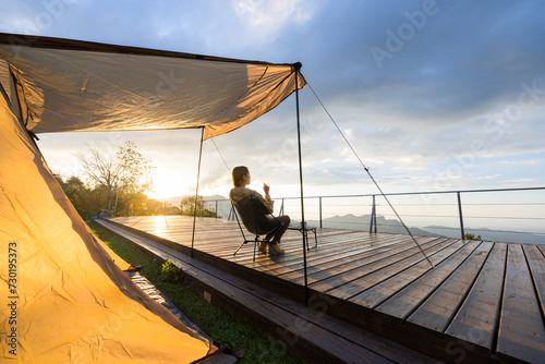 Woman go camping and enjoy the sunset view