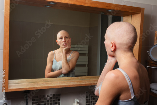 Individual struggle with cancer gazes at reflection, thoughtful photo
