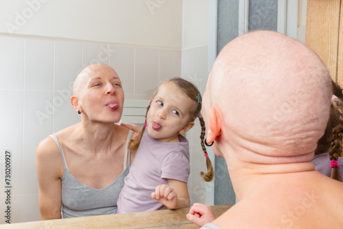 Mom and kid making faces in mirror stay strong fighting cancer