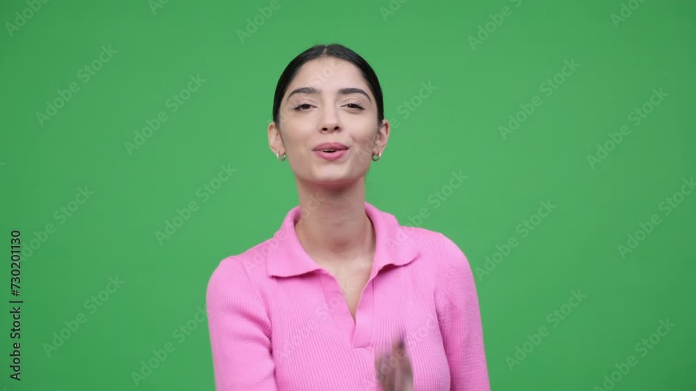 Portrait of a Caucasian young woman sending air kiss on green background. Valentine day celebration, affection and tenderness concept. Portrait of a Caucasian young woman sending air kiss on green background. Valentine day celebration, affection and tenderness concept.