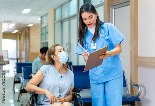 Fotografie Asian nurse is asking patient for personal information and medical record data f