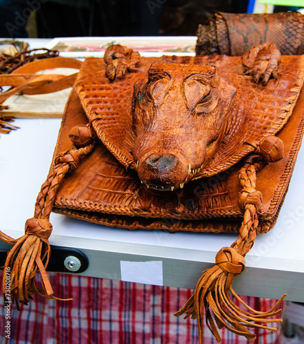 Картината върху платно Frightful crocodile leather woman's bag with real crocodile head for sale at flea market in Paris, France