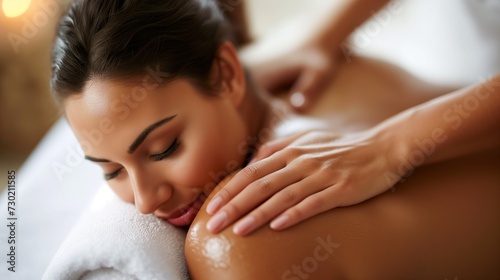 A young woman enjoys a relaxing back massage at a spa  with a serene and peaceful expression on her face.