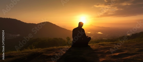 Silhouette of muslim man praying over sunset background.