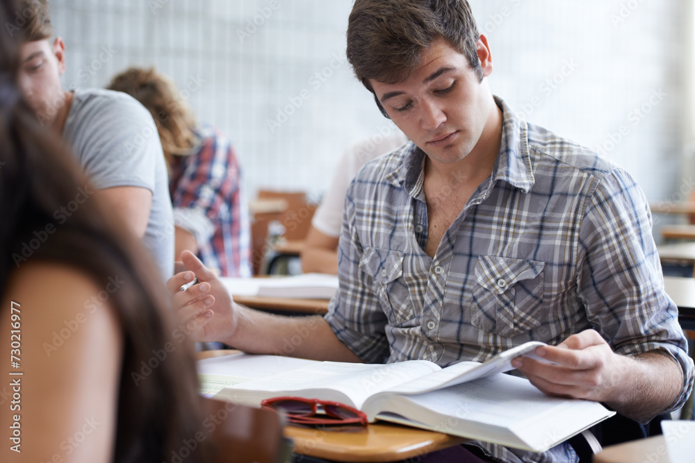 Obraz premium College, books and man in classroom reading for development in learning, opportunity and future. Education, knowledge and growth for ambitious university student in lecture, studying for exam or test