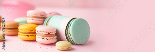 Sweet colorful macarons banner for cafe, confectionery, pastry shop. Copy space. Delicious French macaroons on trendy pastel peachy background. Macarons sale, offer, promotion