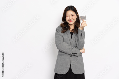 Young Asian businesswoman showing and presenting credit card or personal loan card isolated on white background