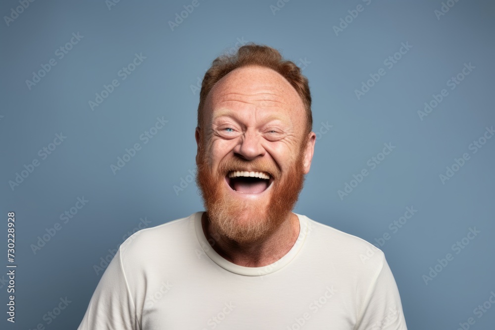 Portrait of a funny senior man with red hair and beard on blue background Portrait of a funny senior man with red hair and beard on blue background