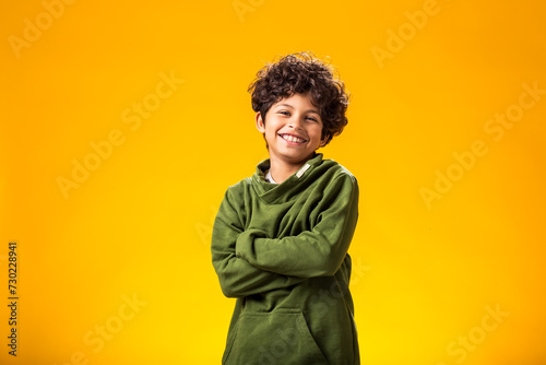 Smiling child boy over yellow background. © Aleksej