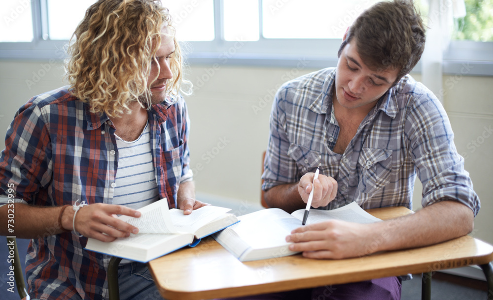 Fototapeta premium Students, reading and textbook for group project in university for academic research, higher education or assignment. Men, friends and college campus for scholarship or learning, helping or studying
