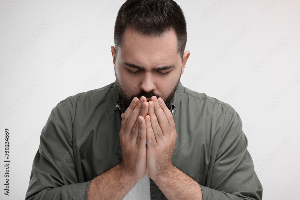 Sick man coughing on white background. Cold symptoms Sick man coughing on white background. Cold symptoms