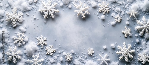 Snowflakes and snow on a pastel gray background, symbolizing Christmas. Winter theme, flat lay, top view, with room for text.