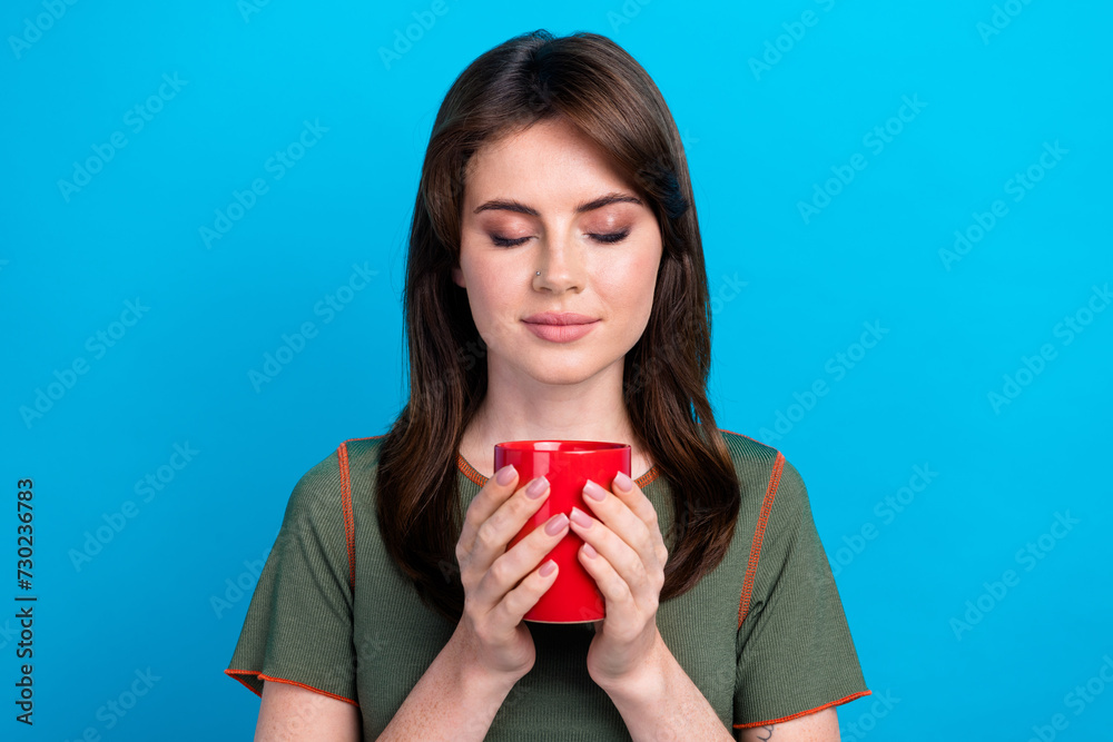 Portrait of lovely positive person closed eyes smell hot chocolate mug isolated on blue color background Portrait of lovely positive person closed eyes smell hot chocolate mug isolated on blue color background