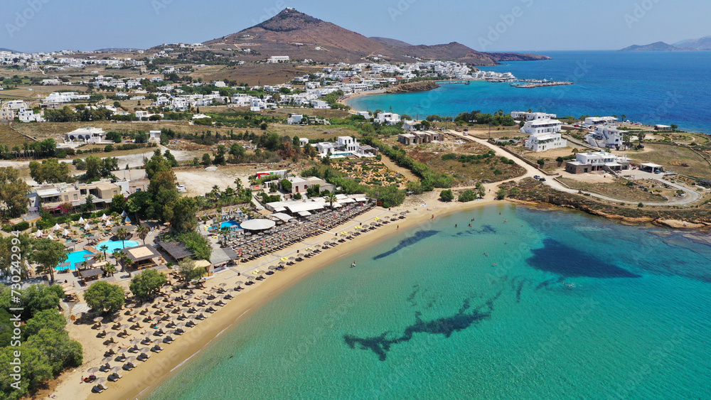 Aerial drone photo from sandy organised with umbrellas and sun beds beach of Pounta with crystal clear emerald sea, Paros island, Cyclades, Greece
