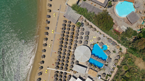 Aerial drone photo from sandy organised with umbrellas and sun beds beach of Pounta with crystal clear emerald sea, Paros island, Cyclades, Greece photo