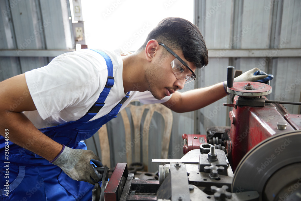 factory worker or technician checking and control lathe machine in factory factory worker or technician checking and control lathe machine in factory