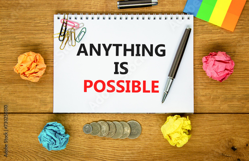 Anything is possible symbol. Concept words Anything is possible on beautiful white note. Beautiful wooden background. Black pen. Colored paper. Business anything possible concept. Copy space.