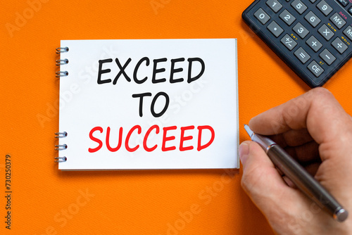 Exceed to succeed symbol. Concept words Exceed to succeed on beautiful white note. Beautiful orange background. Businessman hand. Calculator. Business and exceed to succeed concept. Copy space.