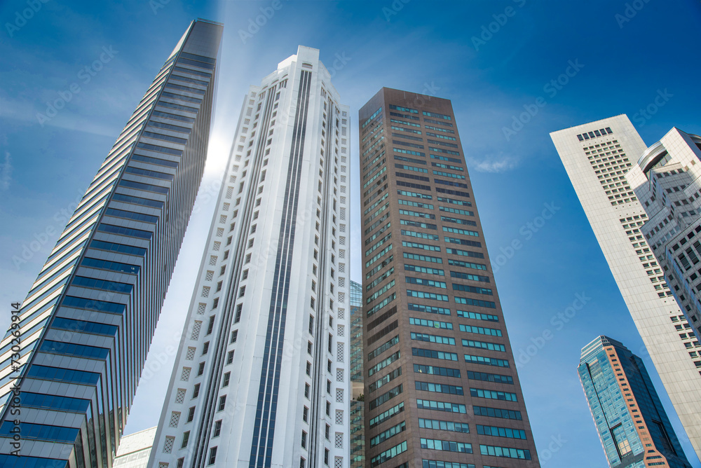 Singapore city skyline of business district downtown on blue sky with cloud in daytime.