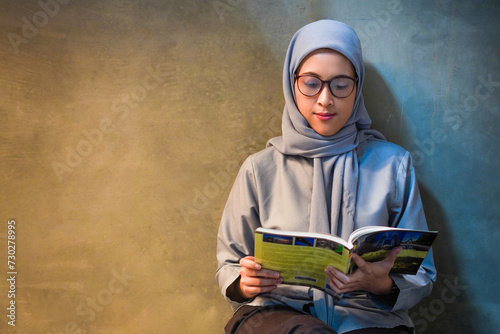 Nerdy islamic girl enjoying her time at the library. Nerdy  Smart girl at library concept photo